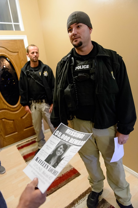 Trent Nelson | The Salt Lake Tribune
Probation Agents Jason Fairbanks, left, and Brian Peterson hand out a flier with information on Kayelyn Louder, who disappeared from her home in Murray on Sept. 27, during a visit to the home of a probationer in West Jordan Wednesday November 19, 2014. Adult Probation and Parole agents handed out fliers throughout the Salt Lake valley to raise awareness of the case.