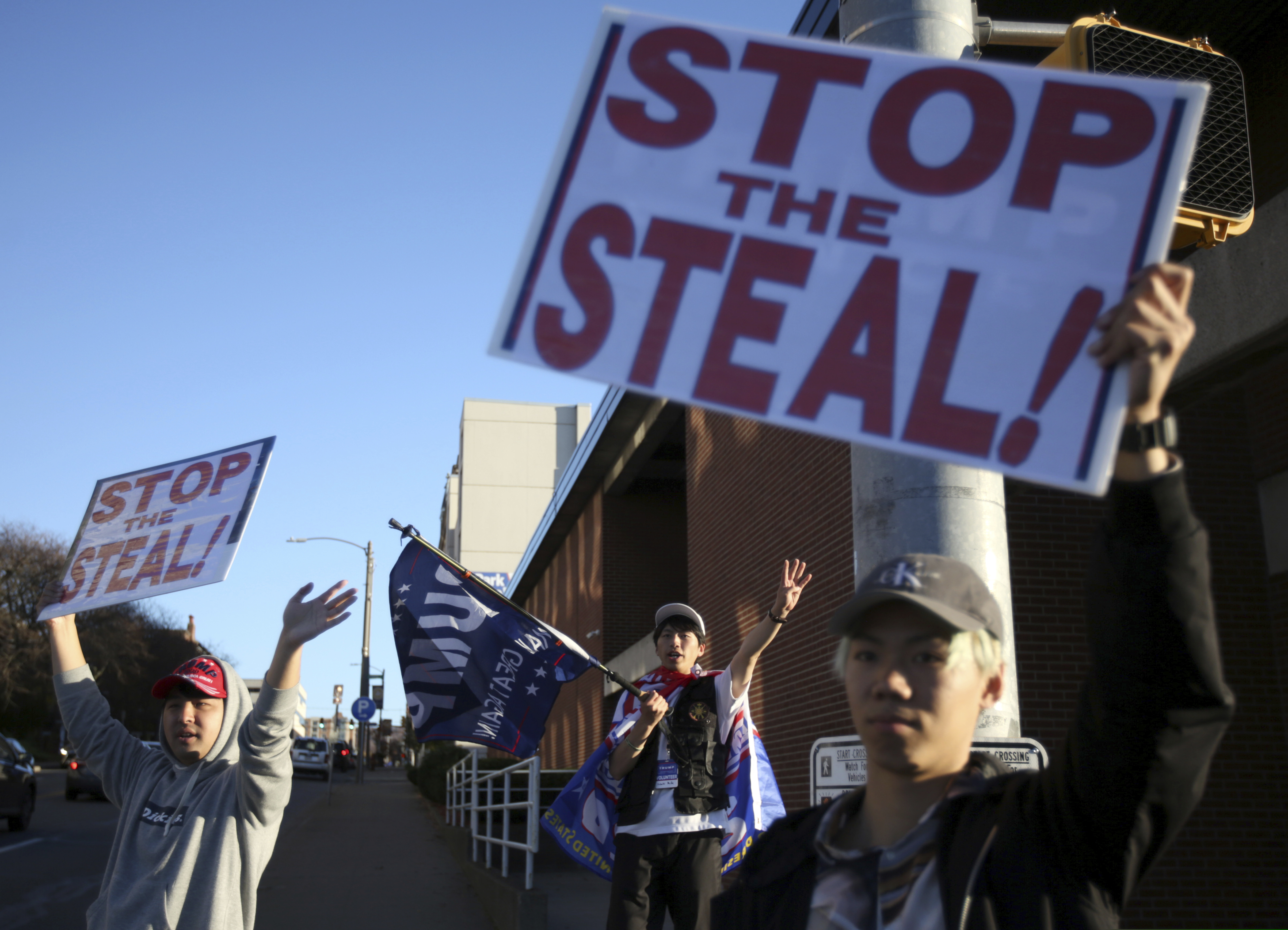 A group of Japanese nationals gather on the streets of Scranton, Pa., to show their support for President Donald Trump on Monday, Nov. 9, 2020. (Jake Danna Stevens/The Times-Tribune via AP)