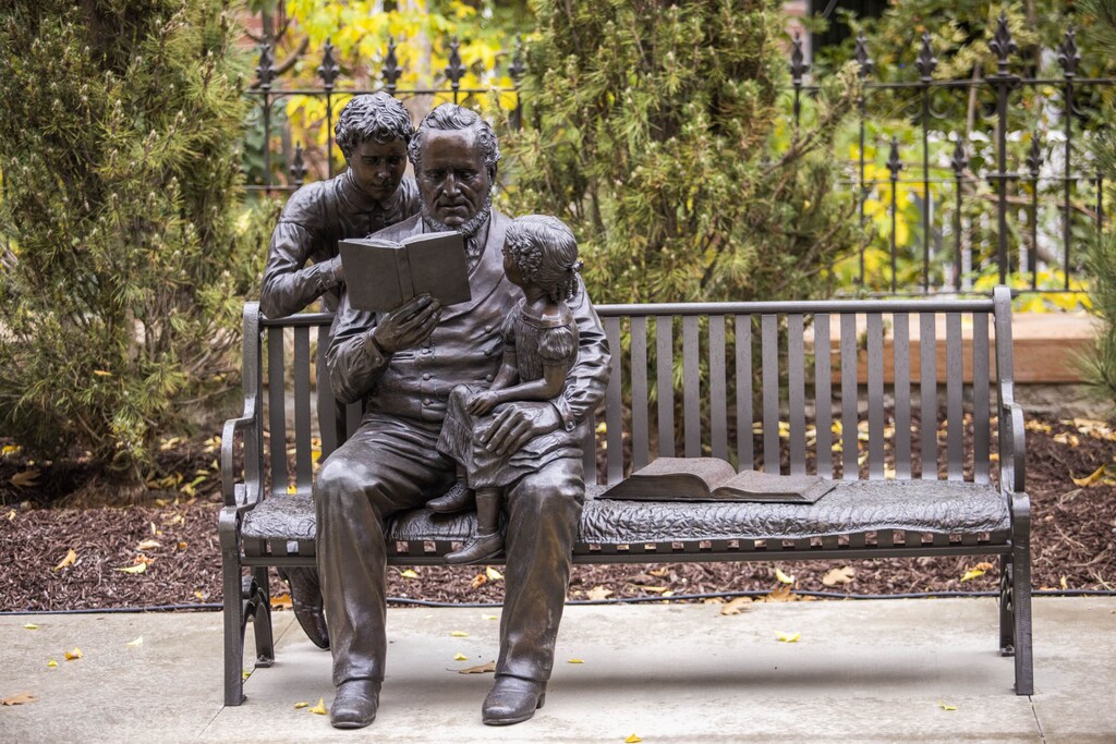 (Courtesy of The Church of Jesus Christ of Latter-day Saints) A statue depicting Brigham Young reading to his grandchildren at the Brigham Young Family Cemetery in Salt Lake City on October 22, 2022.