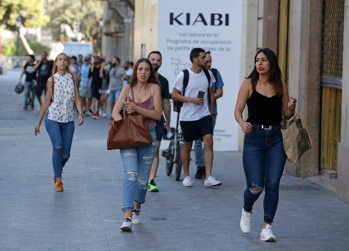 People run down a street in Barcelona, Spain, Thursday, Aug. 17, 2017. Police in the northern Spanish city of Barcelona say a white van has jumped the sidewalk in the city's historic Las Ramblas district, injuring several people. (AP Photo/Manu Fernandez)