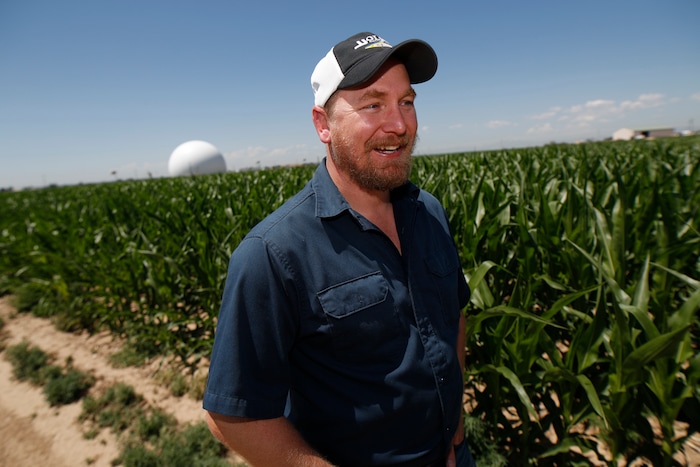 (David Zalubowski | AP Photo) In this Thursday, July 11, 2019, photograph, Kendall DeJonge of the United States Department of Agriculture is shown at a research farm northeast of Greeley, Colo. Researchers are using drones carrying imaging cameras over the fields in conjunction with stationary sensors connected to the internet to chart the growth of crops in an effort to integrate new technology into the age-old skill of farming.