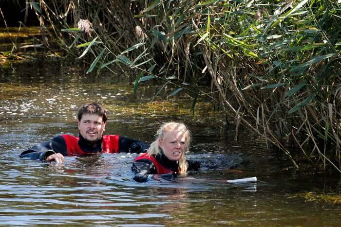 Police search a waterway for body remains related to the ongoing Kim Wall murder investigation at the west coast of Amager close to Copenhagen, Denmark, Wednesday, Aug. 23, 2017.  The investigation continues after the headless torso identified as that of missing Swedish journalist Kim Wall, was found on a beach off Copenhagen. (Jens Dresling/Ritzau via AP)