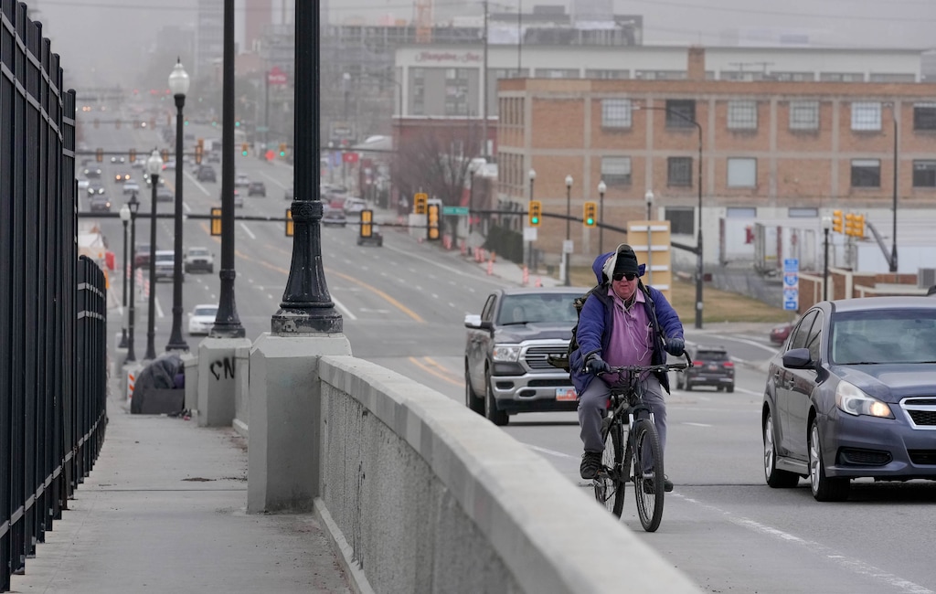 (Francisco Kjolseth  |  The Salt Lake Tribune) A cyclist crosses the 400 South viaduct west of Pioneer Park on Saturday, March 2, 2024. The city is designing a new multipurpose path along 400 South, connecting Poplar Grove to downtown.