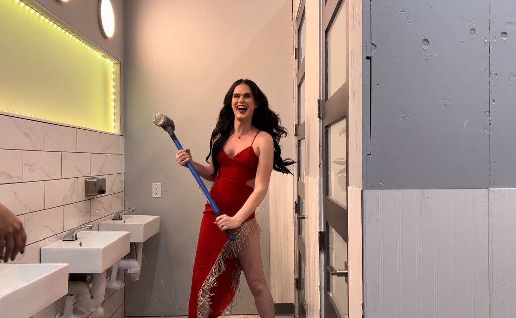 (Jordan Miller | The Salt Lake Tribune) Holden Davis grins while holding a sledgehammer to demolish the wall dividing the male and female restrooms during an event at Club Verse in Salt Lake City on Saturday, November 19, 2022.