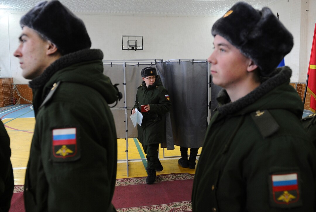 Russian soldiers exit a polling booth as they prepare to cast their ballots in the presidential election in Rostov-ojn-Don, Russia, Sunday, March 18, 2018. Russia's presidential election was tainted Sunday by unprecedented pressure on voters to turn out and incidents of suspected ballot box stuffing, a barely democratic exercise that will grant Vladimir Putin another six years of power. (AP Photo)