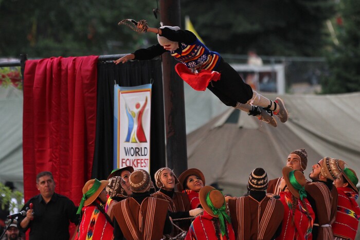 (Daniel Carde | for The Salt Lake Tribune) Performers from Peru toss a dancer in the air at the World Folkfest at the Springville Arts Park, Springville, Thursday, Aug. 1, 2018.
