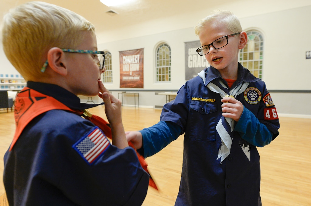 (Francisco Kjolseth | The Salt Lake Tribune) Brody Cook, 6, left, and his brother Landon, 8, talk about some of their merit badges and various aspects of their scout uniforms following a recent Cub Scout activity in Draper. The cook family previously participated in a scout pack sponsored by the Church of Jesus Christ of Latter-day Saints, but elected to continue with the Scouting program at a different location after the church announced it will end its decades-long partnership with the Scouting organization.