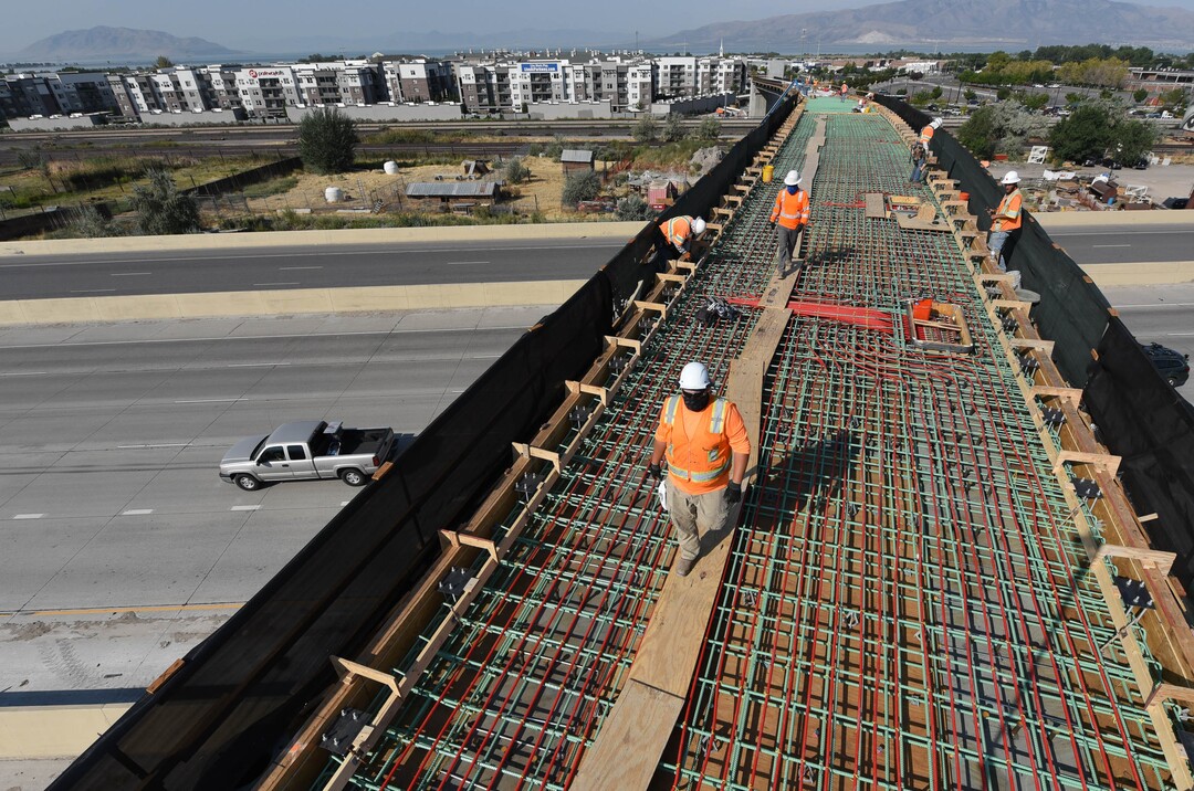 (Francisco Kjolseth  |  The Salt Lake Tribune) UDOT gives a tour of the state’s new longest pedestrian bridge on Thursday, August 20, 2020, connecting Utah Valley University in Orem to student housing and the community on the West side of I-15. Crews are finishing up an extensive hydronic heating system that will pump warm water to keep the bridge clear of snow in the winters, as it gets ready to pour concrete for the walking surface. UDOT will close I-15 in both directions this weekend for work on the nearly 1,000 foot bridge that is 15 feet wide to accommodate pedestrians, cyclists and scooters. Elevators and stairs with small ramps to push up bicycles will be on each side of the bridge.