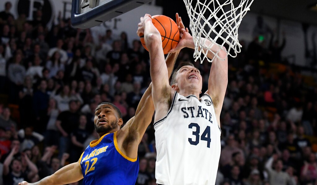 Utah State forward Justin Bean (34) shoots as San Jose State guard Richard Washington (22) defends during the first half of an NCAA college basketball game Tuesday, Feb. 25, 2020, in Logan, Utah. (Eli Lucero/The Herald Journal via AP)