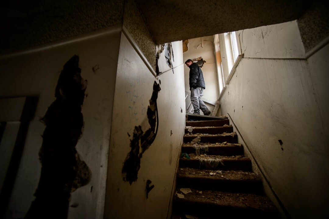 (Trent Nelson | The Salt Lake Tribune)  Jordon Holdaway in a dilapidated, fire-damaged building near 100 South 700 East in Salt Lake City, Thursday Feb. 15, 2018. Other Side Academy has received approval to demolish it for their expansion.