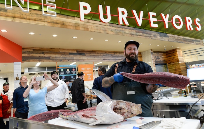 (Francisco Kjolseth  |  The Salt Lake Tribune)  Matthew Cheatham filets an 80 lbs Yellow Fin tuna during opening day of the new Whole Foods Market in Park City on Wednesday, Oct. 18, 2017. 