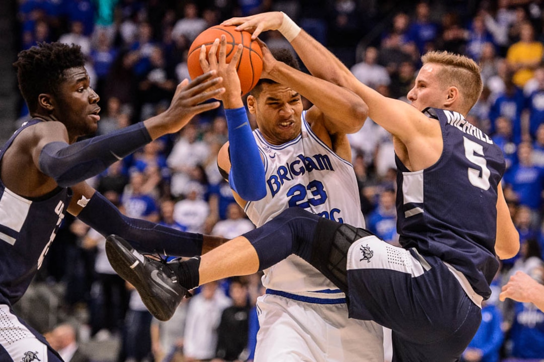 (Trent Nelson | The Salt Lake Tribune)  Brigham Young Cougars forward Yoeli Childs (23) defended by Utah State Aggies center Neemias Queta (23) and Utah State Aggies guard Sam Merrill (5) as BYU hosts Utah State, NCAA basketball in Provo on Wednesday Dec. 5, 2018.