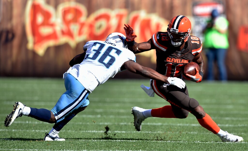 Cleveland Browns wide receiver Kenny Britt (18) tries to avoid a tackle by Tennessee Titans cornerback LeShaun Sims (36) in the first half of an NFL football game, Sunday, Oct. 22, 2017, in Cleveland. (AP Photo/David Richard)