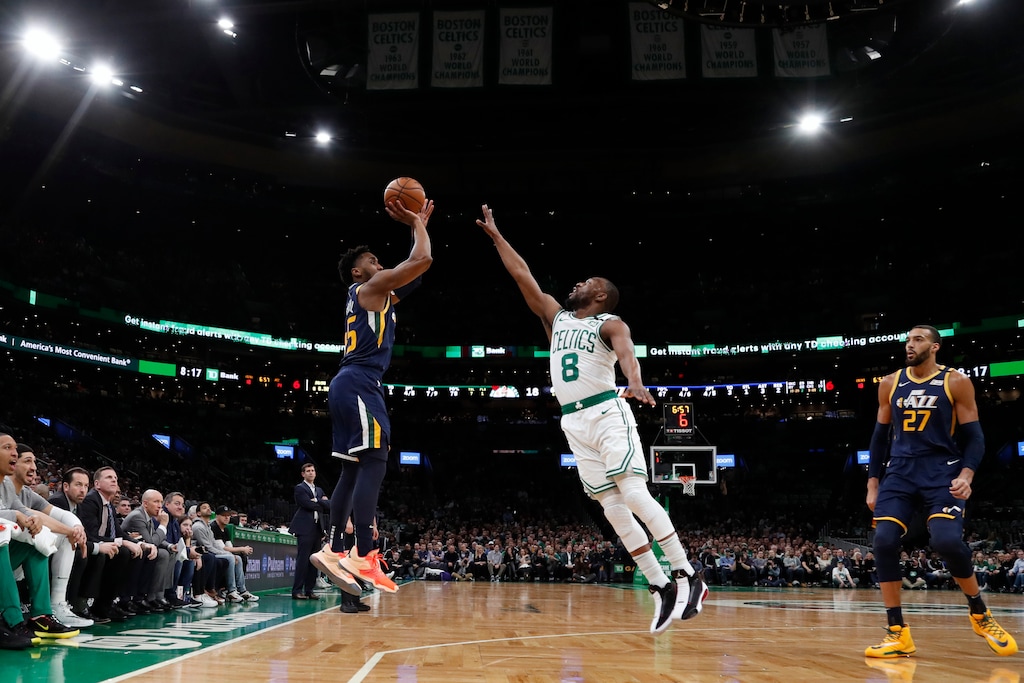 Utah Jazz's Donovan Mitchel, center left, shoots over Boston Celtics' Kemba Walker (8) during the first quarter of an NBA basketball game Friday, March 6, 2020, in Boston. (AP Photo/Winslow Townson)