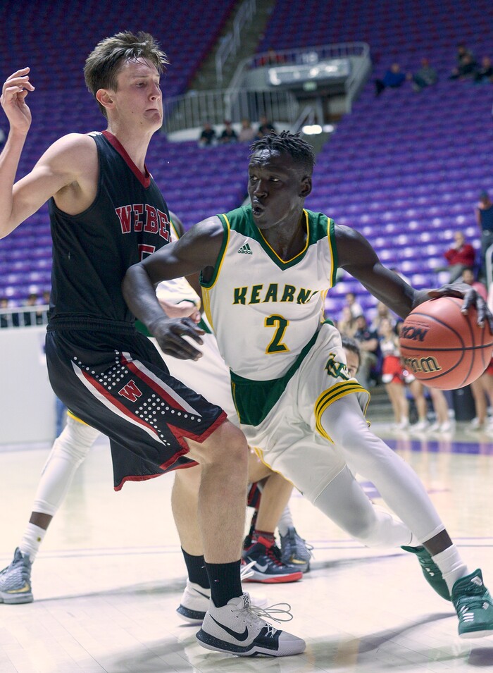 (Leah Hogsten  |  The Salt Lake Tribune) Kearns' David Andrew (03) pushes past Weber's Braedon Iverson (05). Weber defeated Kearns 60-52 in the 6A High School Boys' Basketball Tournament opening game at Weber State University’s Dee Events Center in Ogden, Tuesday, Feb. 27, 2018. 
