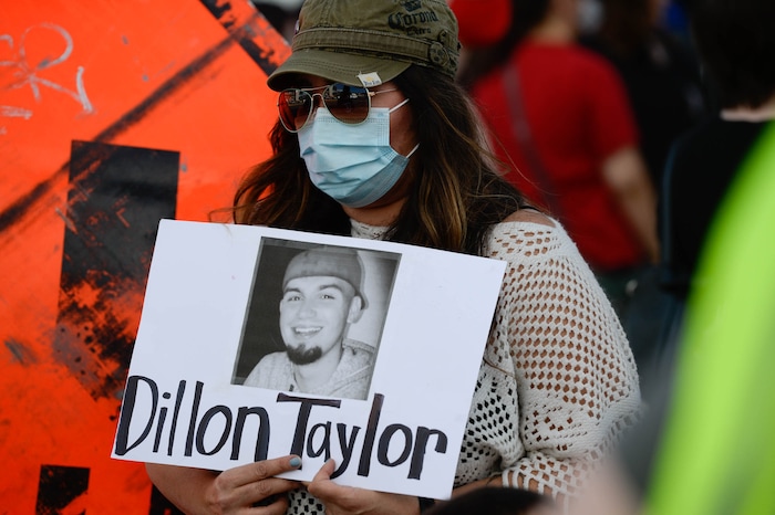 (Francisco Kjolseth  |  The Salt Lake Tribune) Going by the name M. Black, joins the vigil organized by family of Dillon Taylor on the six-year anniversary of his death by the murals of people killed by police near 800 South and 300 West in Salt Lake City on Tuesday, August 11, 2020. Multiple families who’s loved one’s are depicted on the walls joined the vigil as they moved from portrait to portrait to remember them.