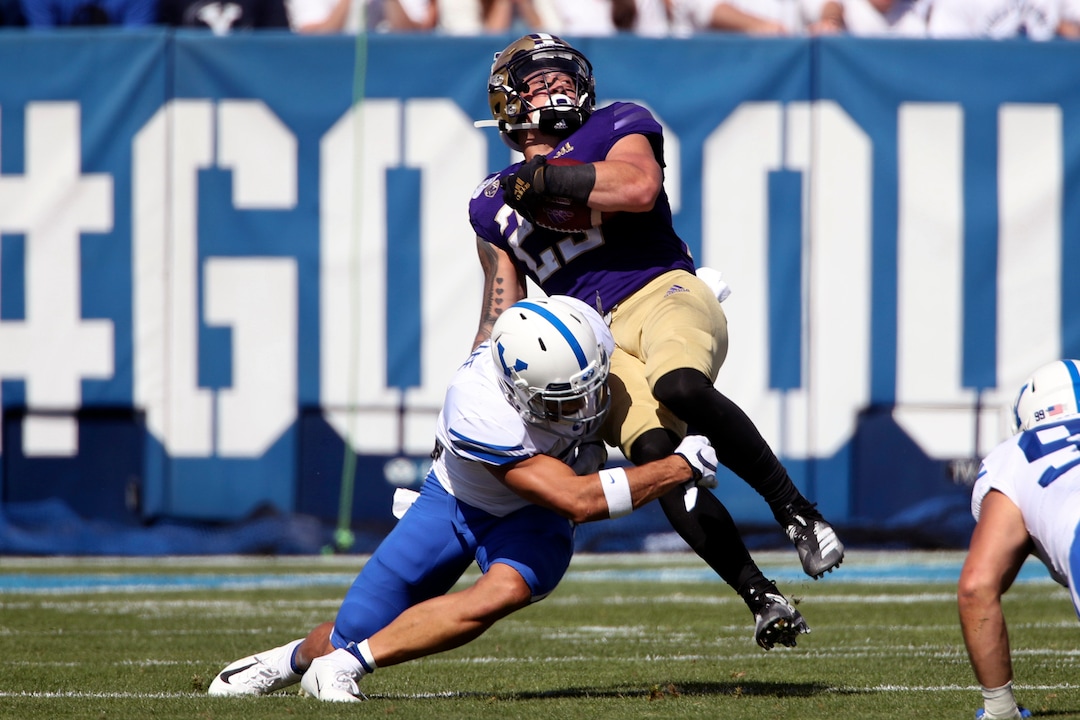 BYU defensive back Austin Lee (2) tackles Washington running back Sean McGrew (25) during the first half of an NCAA college football game, Saturday, Sept. 21, 2019, in Provo, Utah. (AP Photo/George Frey)