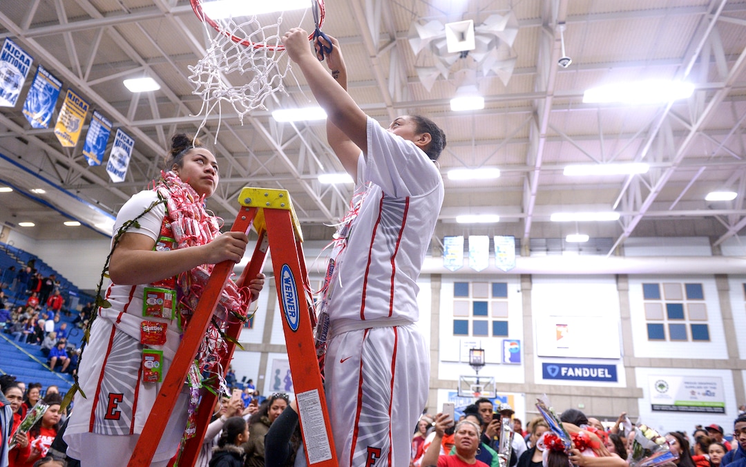 (Leah Hogsten  |  The Salt Lake Tribune)  East's Elina Tausinga and East's Precious Faamausili (15) cut down a portion of the net. East defeated Timpview 68-48 to win the the 5A High School Girls' Basketball Tournament title at SLCC in Taylorsville, Saturday, Feb. 24, 2018. 
