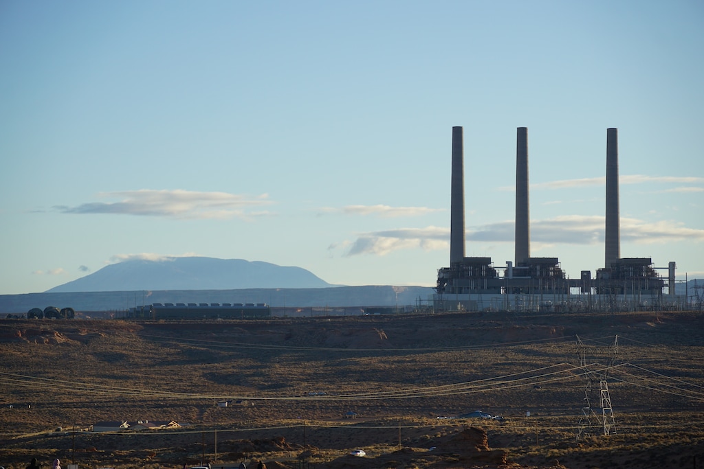 (Zak Podmore | The Salt Lake Tribune) The three 775-foot smokestacks of the Navajo Generating Station have long been a fixture of the skyline near Page, Ariz., and near Navajo Mountain, Utah (visible in background). The stacks were demolished on December 18, 2020.