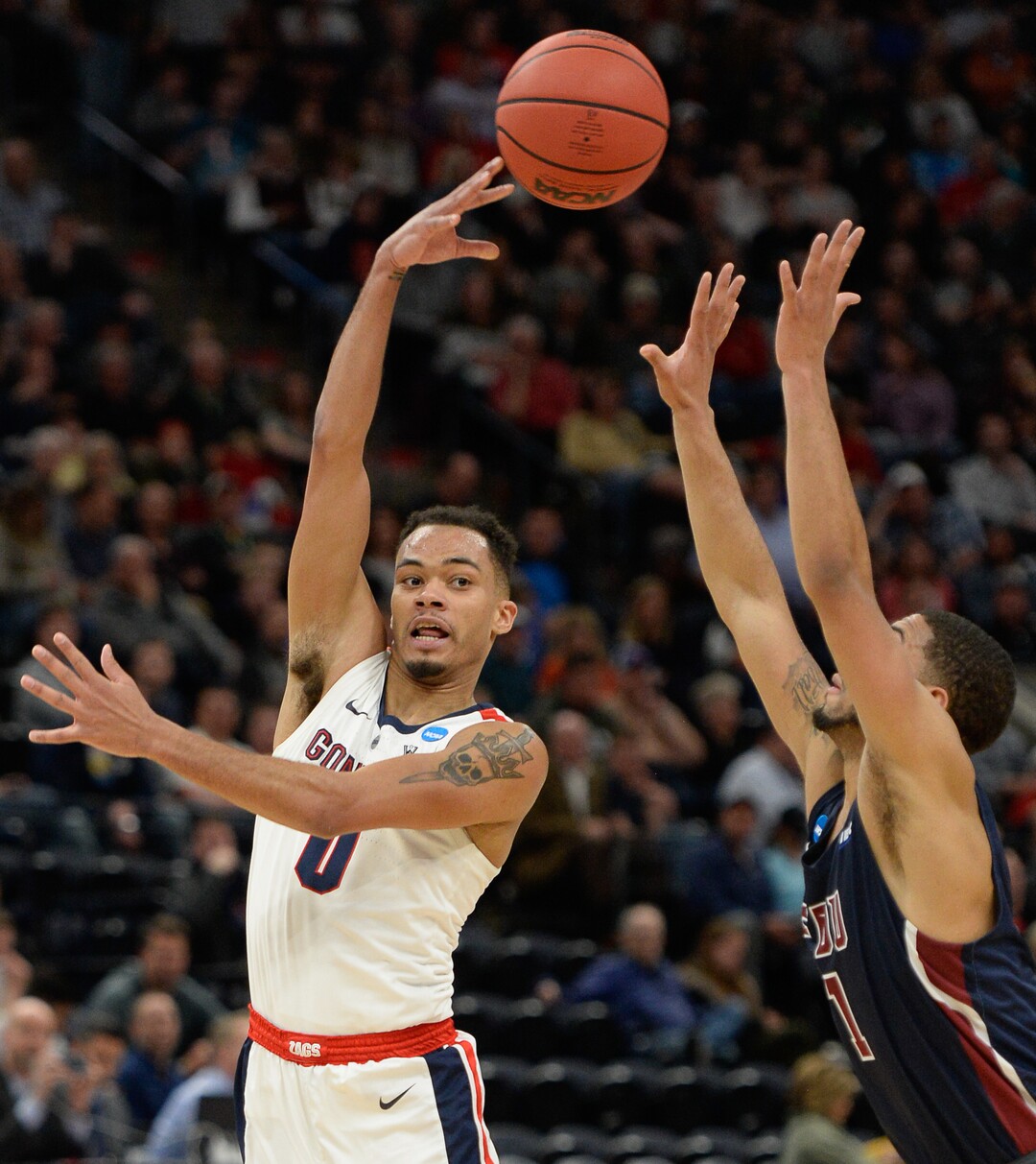 (Francisco Kjolseth  |  The Salt Lake Tribune)  Gonzaga Bulldogs guard Geno Crandall (0) passes past Fairleigh Dickinson Knights guard Darnell Edge (1) as Gonzaga faces Fairleigh Dickinson in their first round menÕs NCAA March Madness tournament game at Vivint Smart Home Arena in Salt Lake City on Thursday, March 21, 2019.