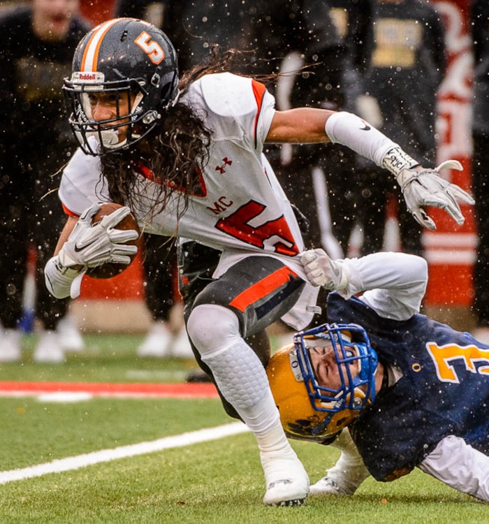 (Trent Nelson | The Salt Lake Tribune)  Mountain Crest's Lepi Taukiuvea (5) and Orem's Ben Daley (3) as Orem faces Mountain Crest in the Class 4A High School State Football Championship game in Salt Lake City, Friday November 17, 2017.