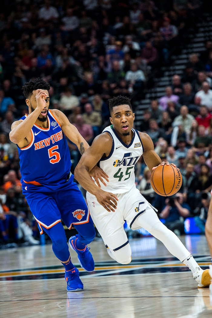 (Chris Detrick  |  The Salt Lake Tribune)  Utah Jazz guard Donovan Mitchell (45) runs past New York Knicks guard Courtney Lee (5) during the game at Vivint Smart Home Arena Friday, January 19, 2018.  