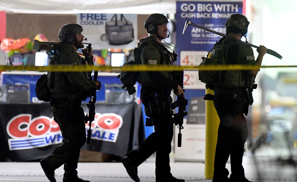 (Will Lester/Inland Valley Daily Bulletin/SCNG via AP) Heavily armed police officers exit the Costco following a shooting inside the wholesale warehouse in Corona, Calif., Friday, June 14, 2019. A gunman opened fire inside the store during an argument, killing a man, wounding two other people and sparking a stampede of terrified shoppers before he was taken into custody, police said. The man involved in the argument was killed and two other people were wounded, Corona police Lt. Jeff Edwards said.