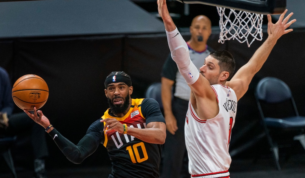 (Rick Egan | The Salt Lake Tribune) Utah Jazz guard Mike Conley (10) tosses a pass, as  Chicago Bulls center Nikola Vucevic (9) defends, in NBA action between the Utah Jazz and the Chicago Bulls, at Vivint Arena, on Friday, April 2, 2021.