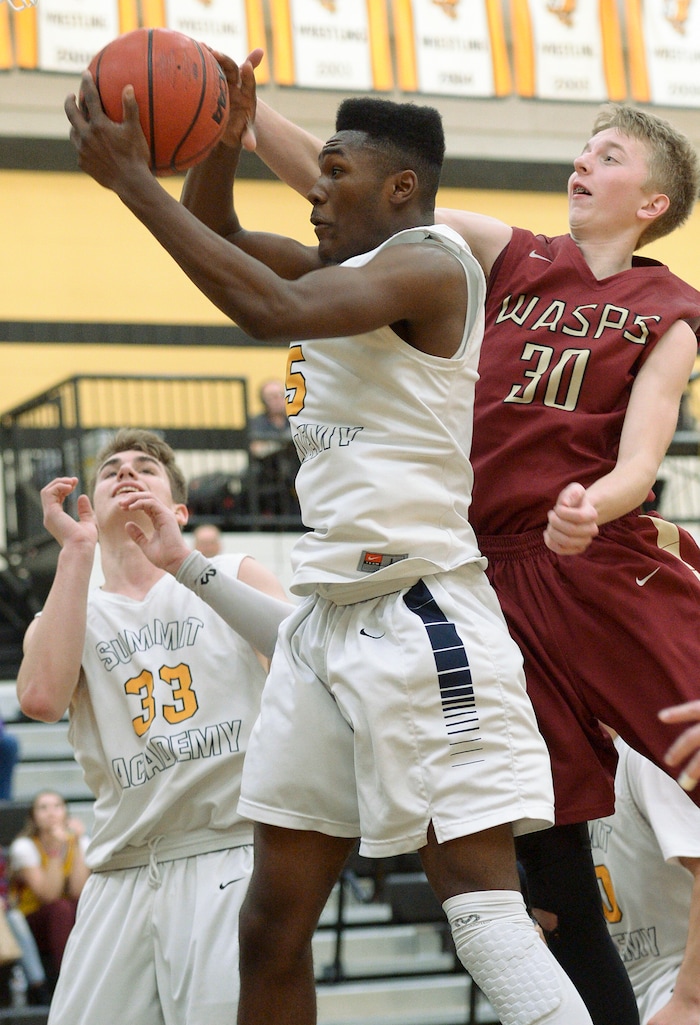 (Leah Hogsten  |  The Salt Lake Tribune) Juab's Kollin Robertson tries to stop Summit's Jalexus Gilson. Juab High School boys' basketball team defeated Summit Academy 61-58 during their 3A State tournament game in Heber  Saturday, Feb. 16, 2018.