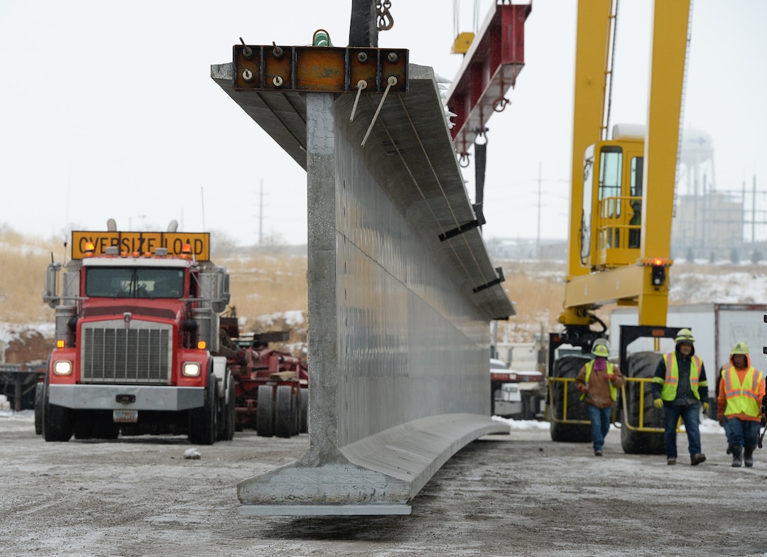 (Francisco Kjolseth  |  The Salt Lake Tribune)  UDOT gets ready to place some of the world's largest-ever bridge beams, and the largest in Utah state history with a span of 203 ft long and just over 8 ft tall, as crews load one on a truck following manufacturing at Forterra Structural Precast in Kearns on Tuesday, Dec. 11, 2018. A total of six beams will be installed in the technology corridor in Lehi later this week.