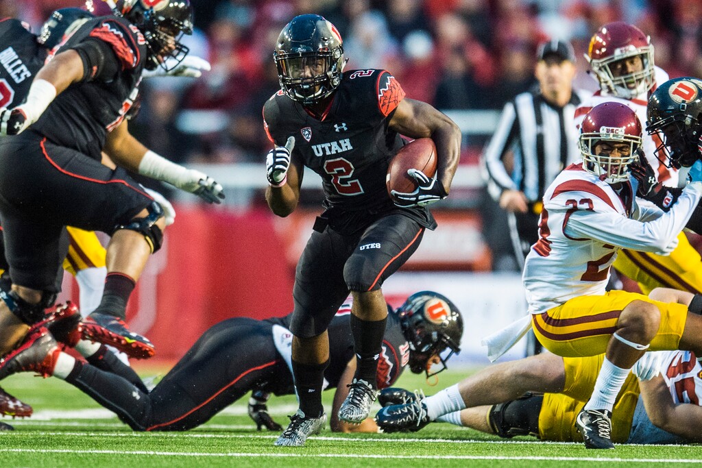 Chris Detrick  |  The Salt Lake TribuneUtah Utes running back Zack Moss (2) runs past USC Trojans defensive back Leon McQuay III (22) during the first half of the game at Rice-Eccles Stadium Friday September 23, 2016. 