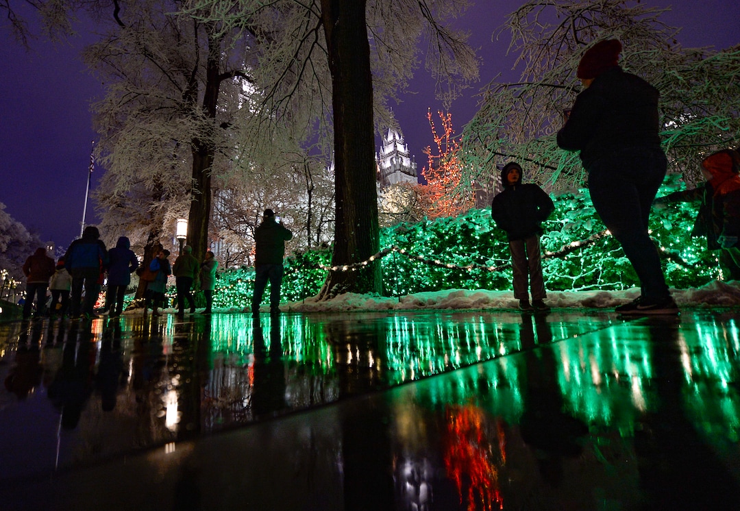 (Francisco Kjolseth  |  The Salt Lake Tribune)  Visitors take in the sights as Temple Square in Salt Lake City comes to life Friday, November 29, 2019, as hundreds of thousands of colorful LED bulbs light up, a yearly tradition that started in 1965. The lights will run through the end of the year.