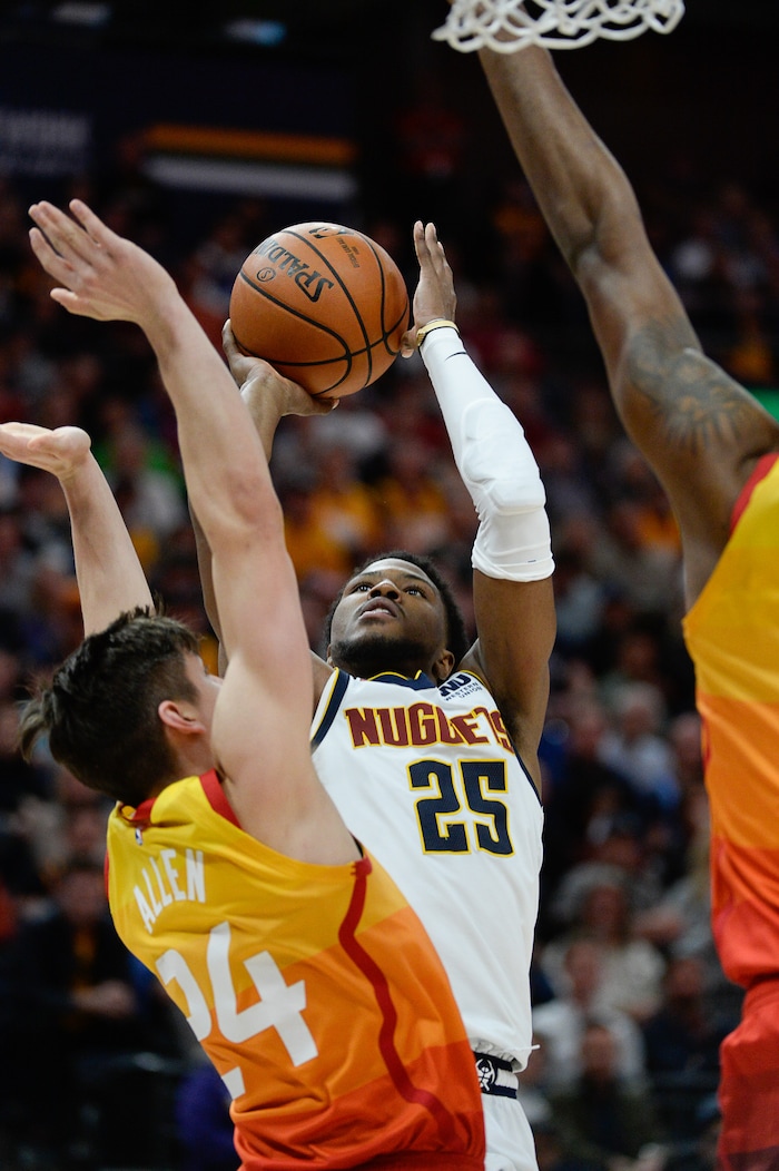 (Francisco Kjolseth  |  The Salt Lake Tribune)  Denver Nuggets guard Malik Beasley (25) shoots over Utah Jazz guard Grayson Allen (24) as the Utah Jazz host the Denver Nuggets in their NBA game at Vivint Smart Home Arena Tuesday, April 9, 2019, in Salt Lake City.