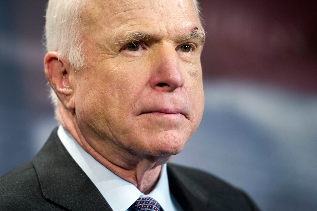 FILE - In this July 27, 2017, file photo, Sen. John McCain, R-Ariz., speaks to reporters on Capitol Hill in Washington. Legislative budget analysts say a possibly doomed Republican health care bill would mean a first-year loss of $1.7 billion of funding for Arizona for the Medicaid eligibility expansion and the health exchange. McCain says on Friday, Sept. 22, 2017, he won't vote for the Republican bill repealing the Obama health care law. His statement likely deals a fatal blow to the last-gasp GOP measure in a Senate showdown expected next week. The Arizona Republican says he can't back the partisan GOP measure because "we could do better working together, Republicans and Democrats." (AP Photo/Cliff Owen, File)