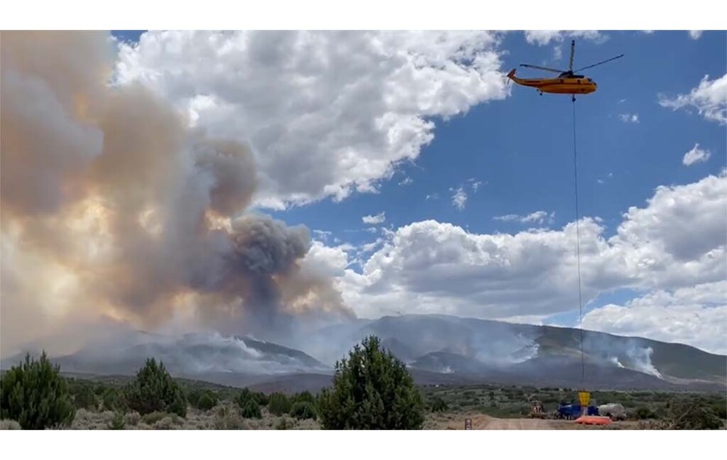 (Utah Fire Info) A helicopter dips from a “pumpkin" water tank to suppress flames from the Halfway Hill Fire near Fillmore, which grew to 6,640 acres in 24 hours.