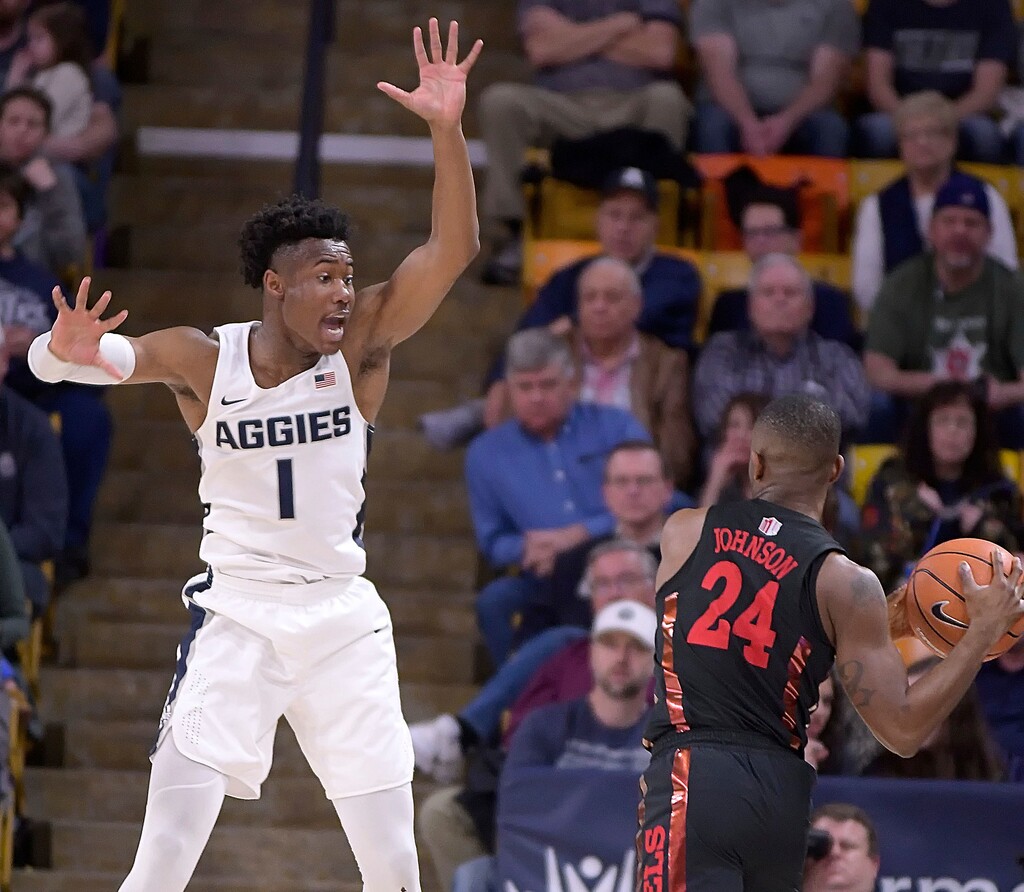 UNLV guard Jordan Johnson (24) looks to pass the ball as Utah State guard Koby McEwen (1) defends during an NCAA college basketball game Saturday, March 3, 2018, in Logan, Utah. (Eli Lucero/The Herald Journal via AP)