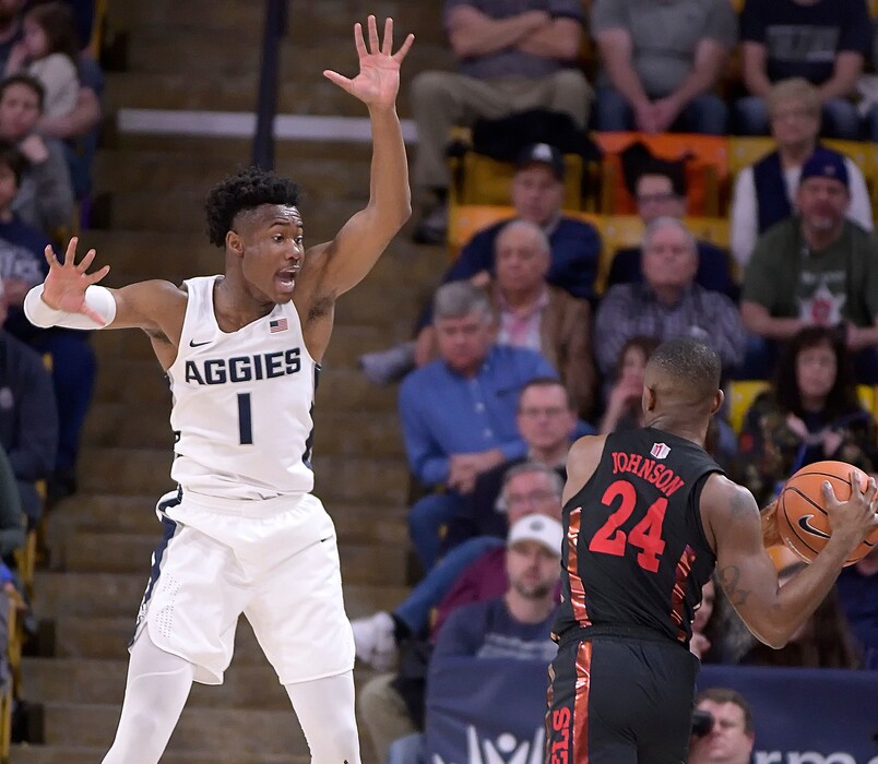 UNLV guard Jordan Johnson (24) looks to pass the ball as Utah State guard Koby McEwen (1) defends during an NCAA college basketball game Saturday, March 3, 2018, in Logan, Utah. (Eli Lucero/The Herald Journal via AP)
