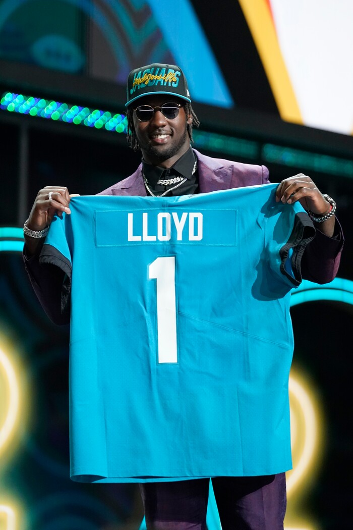 Utah linebacker Devin Lloyd holds a team jersey after he was chosen by the Jacksonville Jaguars with the 27th pick at the 2022 NFL Draft, Thursday, April 28, 2022, in Las Vegas. (AP Photo/Steve Luciano)