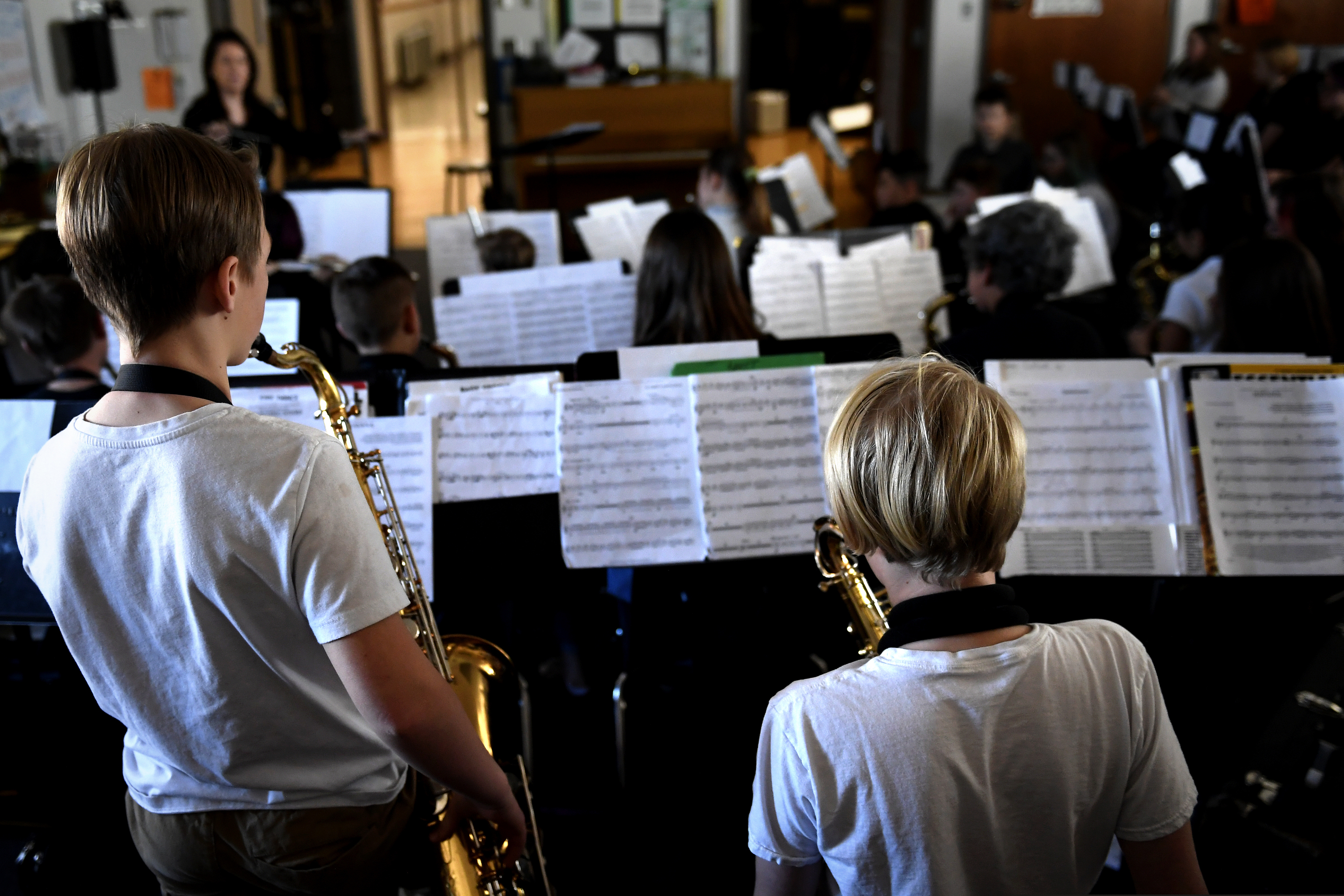 Students in a combined beginner and concert band class work on their music taught by Michelle Koyama, executive principle of Skinner and Lake Middle Schools, at the school during the first day of the Denver Public Schools teachers strike, Monday, Feb. 11, 2019, in Denver.  (Joe Amon/The Denver Post via AP)