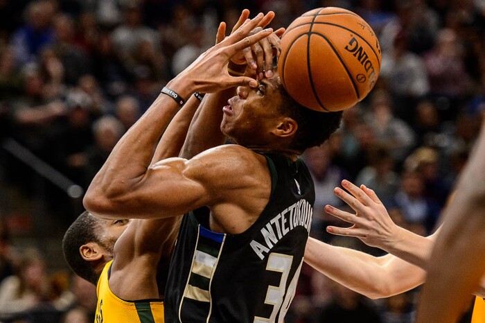 (Trent Nelson | The Salt Lake Tribune)  Milwaukee Bucks forward Giannis Antetokounmpo (34) and Utah Jazz guard Alec Burks (10) fumble for a rebound, as the Utah Jazz host the Milwaukee Bucks, NBA basketball in Salt Lake City Saturday November 25, 2017.