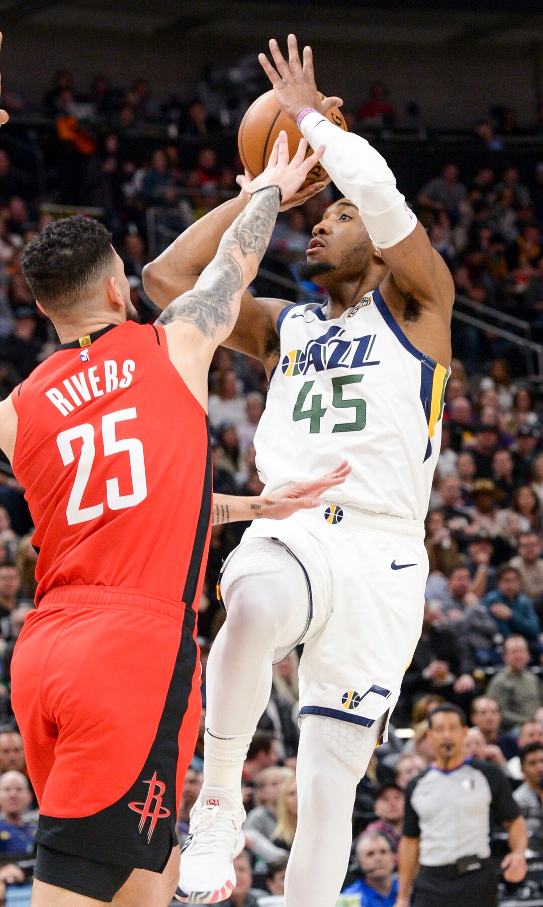 (Leah Hogsten  |  The Salt Lake Tribune)  Utah Jazz guard Donovan Mitchell (45) looks for the shot atop Houston Rockets guard Austin Rivers (25). The Utah Jazz host the Houston Rockets at Vivint Arena, Feb. 22, 2020.