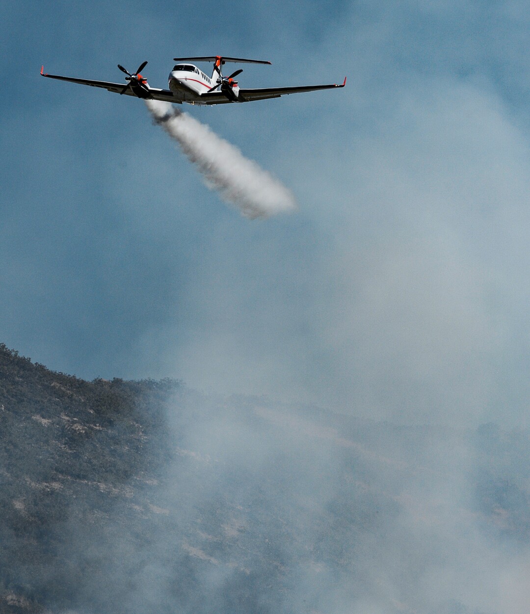 (Francisco Kjolseth  |  The Salt Lake Tribune)  Air crews battle the fire along the East Bountiful bench that grew to 150 acres early Friday morning, Aug. 30, 2019, and destroyed three homes. On Sept. 2, officials said the fire was 100% contained.