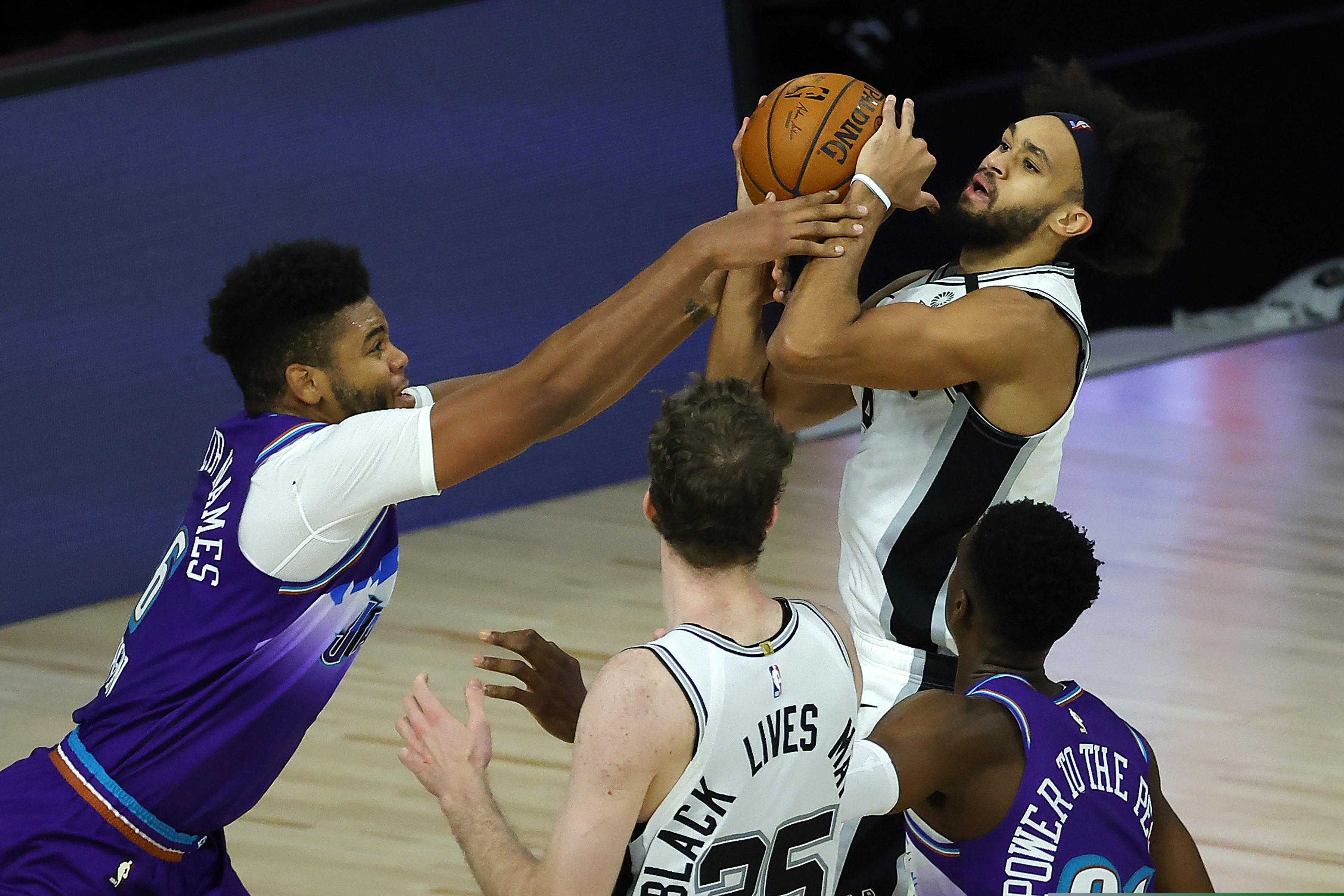(Kevin C. Cox | Pool via AP) Utah Jazz' Juwan Morgan (16), fouls San Antonio Spurs' Derrick White during second half of an NBA basketball game Friday, Aug. 7, 2020, in Lake Buena Vista, Fla.