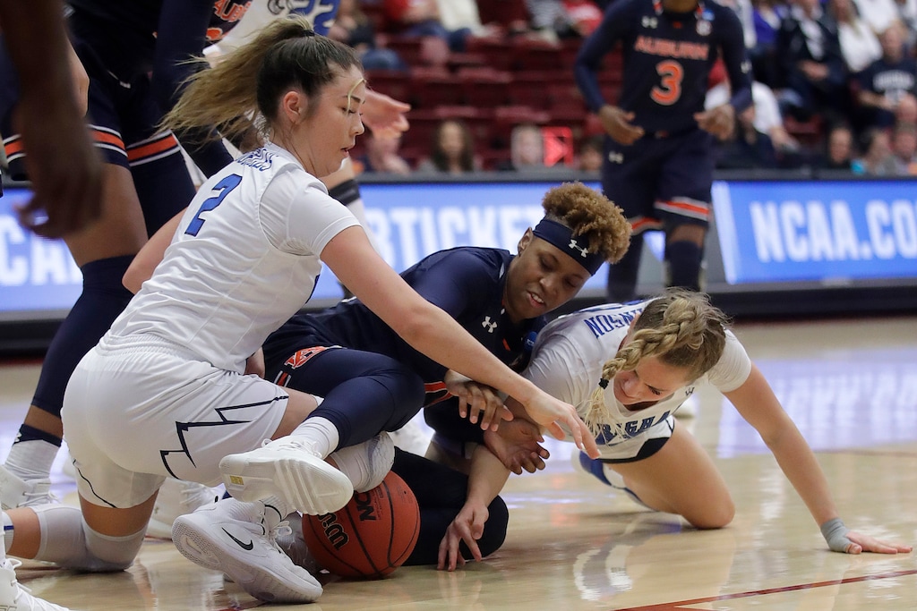 Auburn guard Daisa Alexander, center, reaches for the ball between BYU guard Shaylee Gonzales, left, and guard Paisley Johnson during the first half of a first-round game in the NCAA women's college basketball tournament in Stanford, Calif., Saturday, March 23, 2019. (AP Photo/Jeff Chiu)