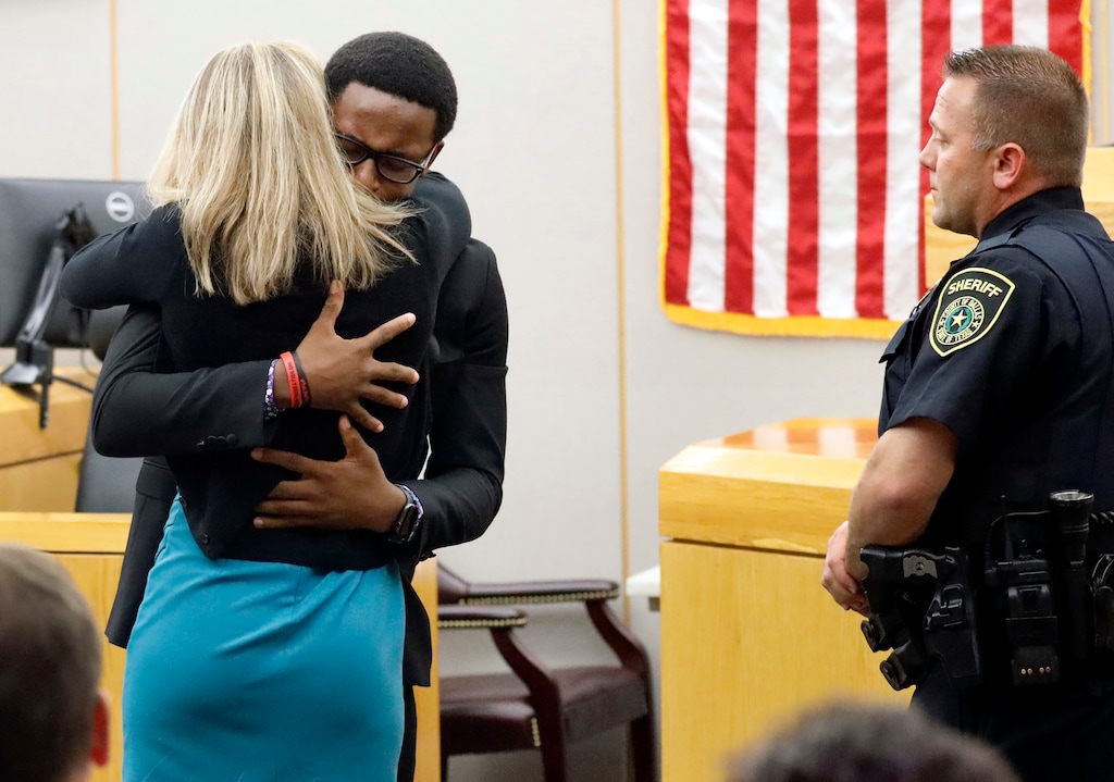 (Tom Fox | The Dallas Morning News file photos) Botham Jean's younger brother Brandt Jean hugs convicted murderer and former Dallas Police Officer Amber Guyger after delivering his impact statement to her after she was sentenced to 10 years in jail, Wednesday, Oct. 2, 2019, in Dallas. Guyger shot and killed Botham Jean, an unarmed 26-year-old neighbor in his own apartment last year. She told police she thought his apartment was her own and that he was an intruder.
