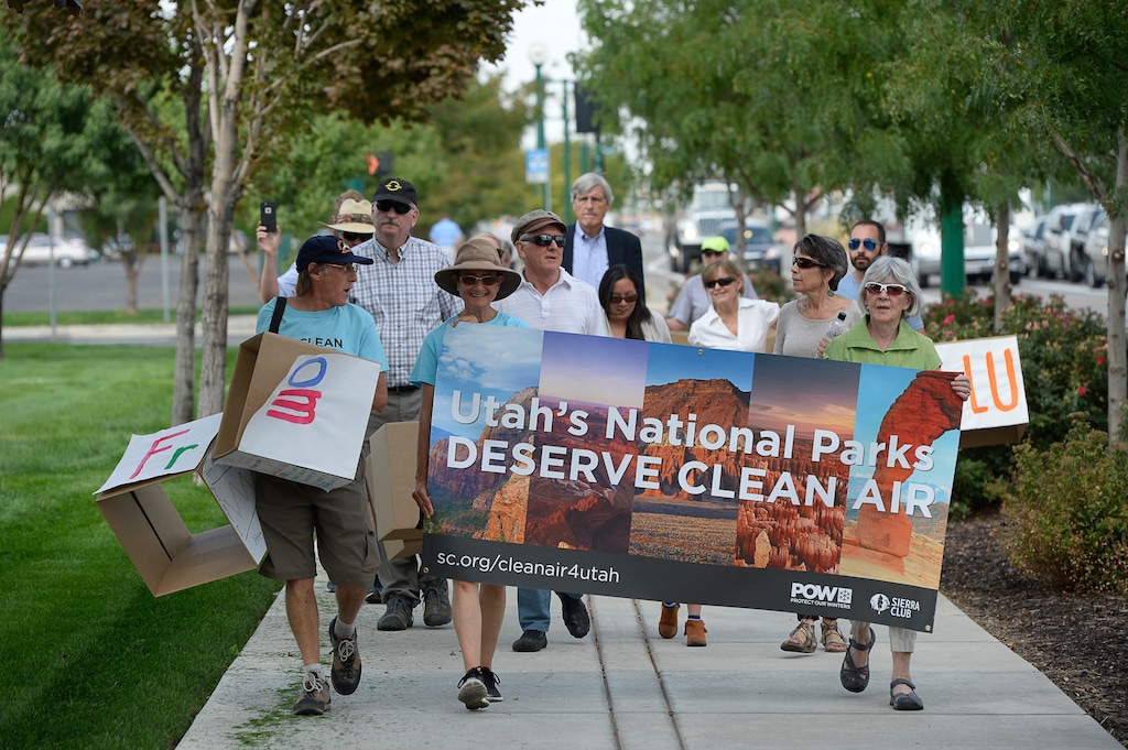 In this Aug. 23, 2016 photo, clean air, public health and national park advocates march to Rocky Mountain Power headquarters in Salt Lake City, in support of the Environmental Protection Agency's (EPA) recently approved plan to reduce coal pollution in beloved national parks such as Arches, Canyonlands and Zion. A 20-year plan by Utah's largest electricity provider stipulating that it will not add pollution-control systems to its coal power plants has received criticism from some in the state who say the proposal may violate a U.S. Environmental Protection Agency requirement and get in the way of the federal push to curb regional haze, The Salt Lake Tribune reports. (Francisco Kjolseth/The Salt Lake Tribune via AP)