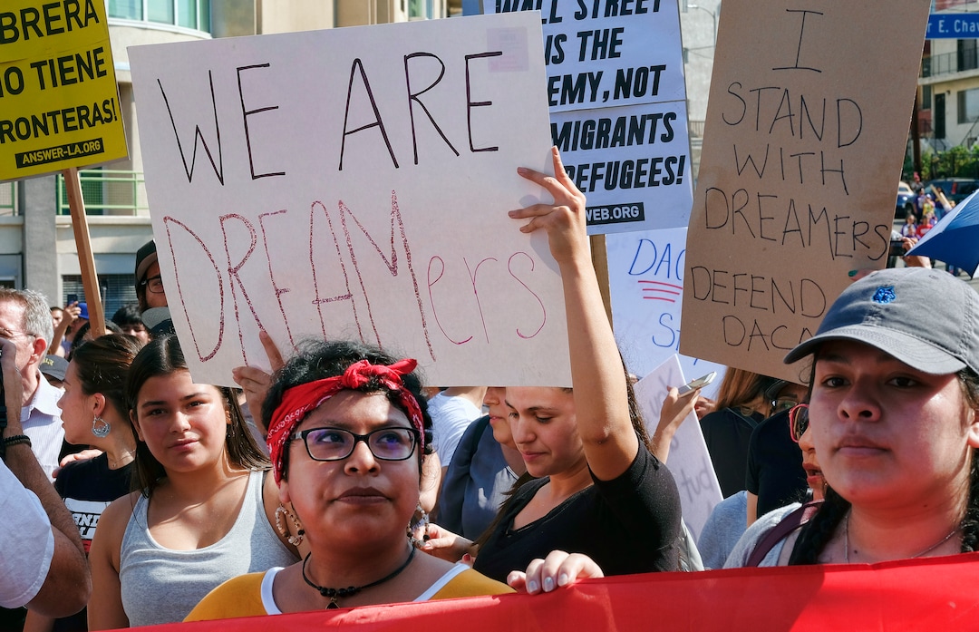 Supporters of the Deferred Action for Childhood Arrivals, or DACA chant slogans and hold signs while joining a Labor Day rally in downtown Los Angeles on Monday, Sept. 4, 2017. President Donald Trump is expected to announce this week that he will end the Deferred Action for Childhood Arrivals, but with a six-month delay, according to two people familiar with the decision-making. (AP Photo/Richard Vogel)