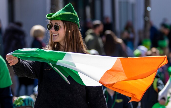 (Rick Egan | The Salt Lake Tribune) Bridget fuller waves the Irish flag as she walks with the Flynn Clan, in St. Patrick's Parade at the Gateway in Salt Lake City, on Saturday, March 12, 2022.