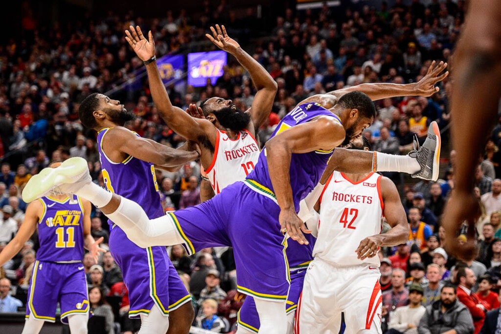 (Trent Nelson | The Salt Lake Tribune)  Houston Rockets guard James Harden (13) collides with Utah Jazz forward Derrick Favors (15). The Utah Jazz host the Houston Rockets, NBA basketball in Salt Lake City on Thursday Dec. 6, 2018.