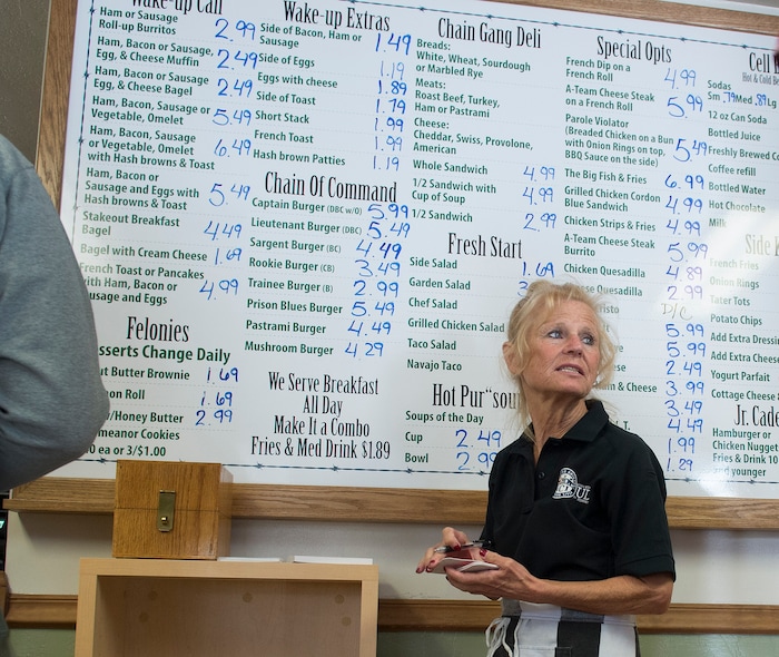 (Leah Hogsten  |  The Salt Lake Tribune) The Serving Time Caf is the brainchild of Carolyn Price, right, a correctional supervisor at the state prison and manager of the caf. Menu items often have cheeky names like the Prison Blues Burger, or the Parole Violator and desserts are listed under Felonies. Every Monday through Friday, a half-dozen or so Level 4 inmates file out of the Olympus Facility at the Utah State Prison to cook, bake and serve the public at the Serving Time Caf. The operation is part of Utah Department of Corrections Industries (UCI) and is aimed at helping inmates return to society.